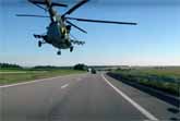 Helicopter Flies Low Along The Motorway