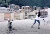 Two Neighbors Play Tennis Across Rooftops In Italy