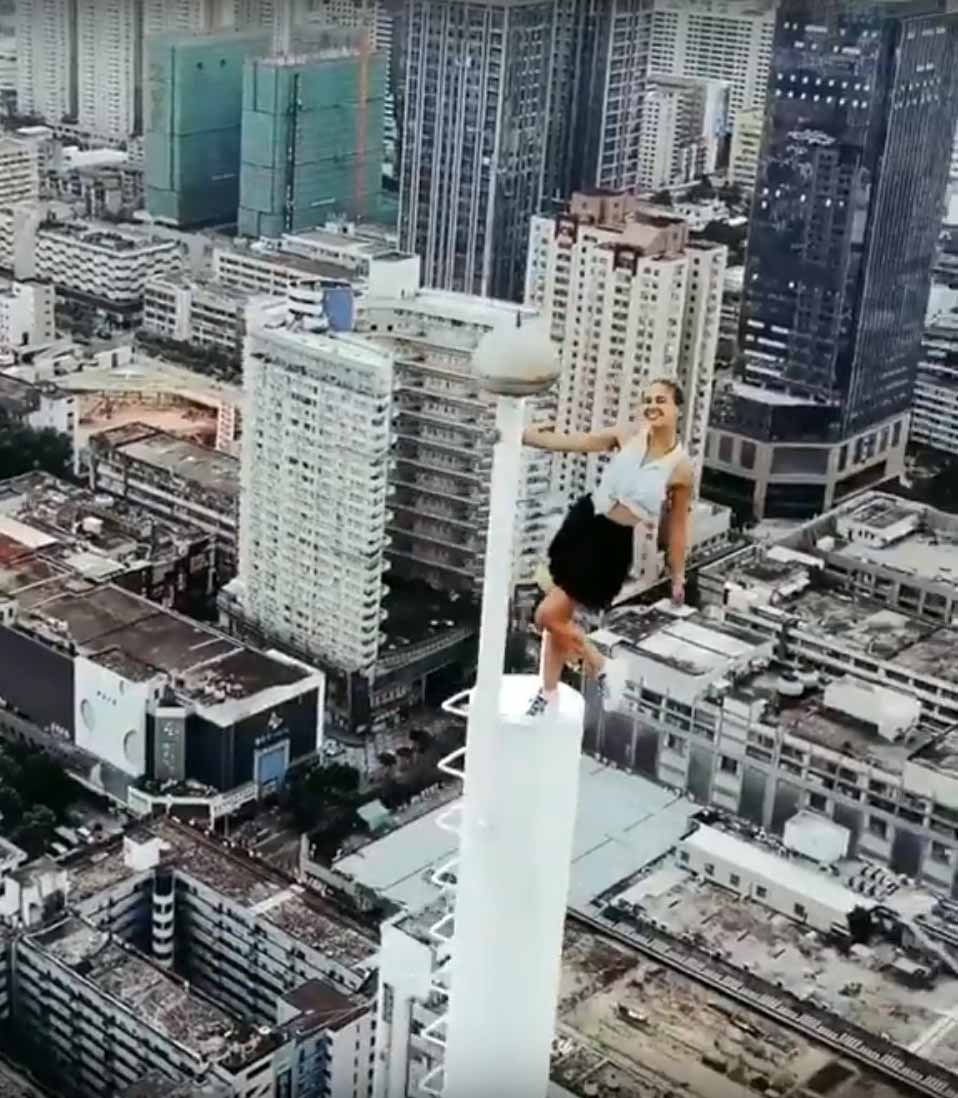 Girl in skirt climbs clearance tower